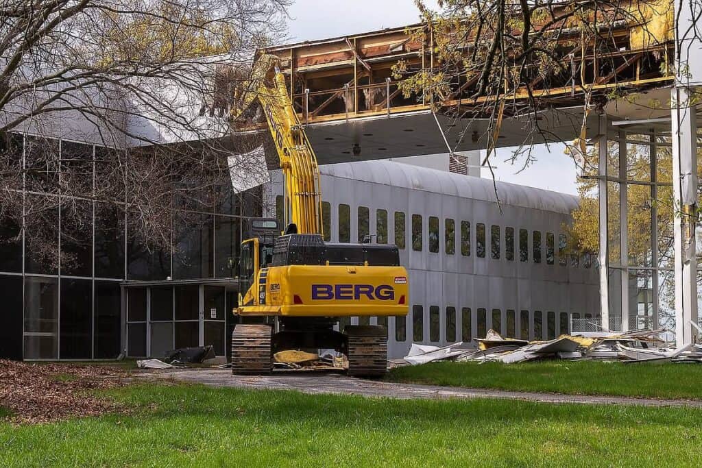 Excavator at the former COMSAT Laboratories on day zero of demolition